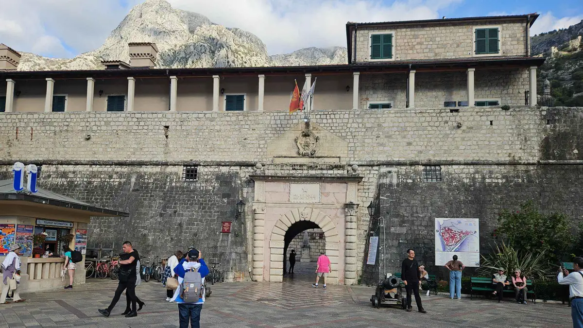 Walking tour group in a narrow stone street of Kotor old town